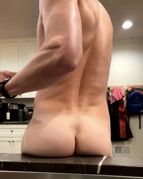 Having some fun, washing dishes naked. 