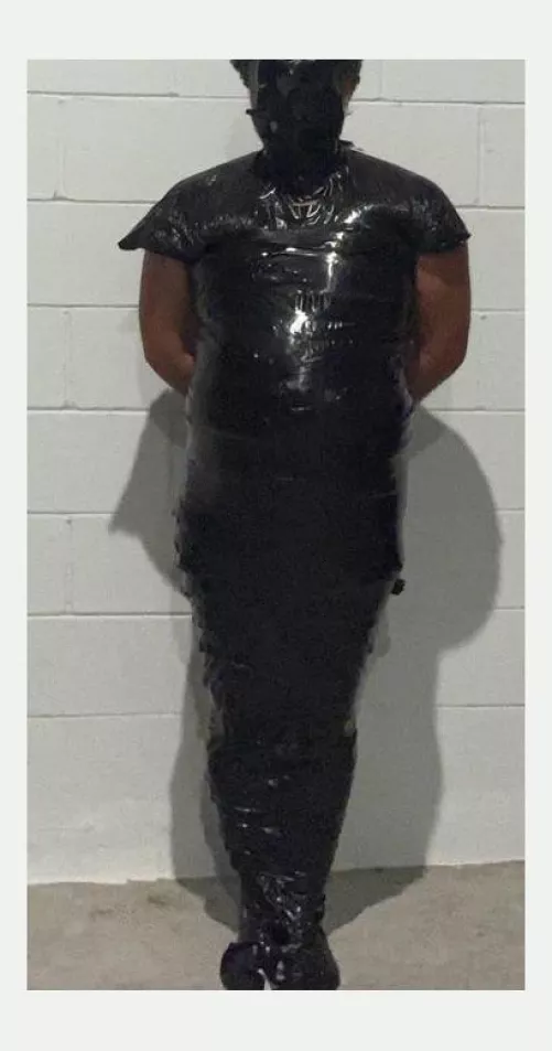 Mummified ln black tape