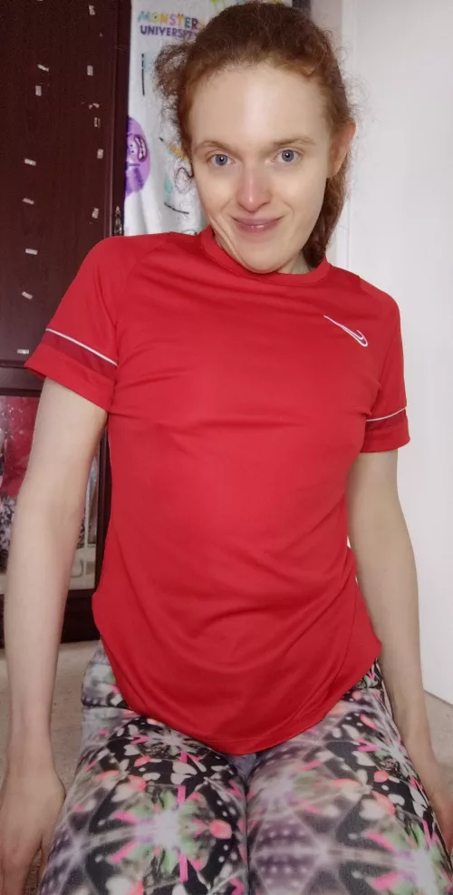 A redhead in a red gym shirt is sexy 