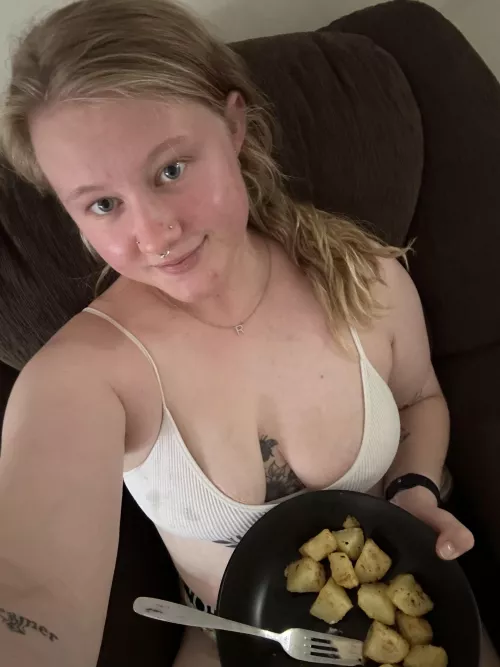 Chubby girl eating potatoes yum