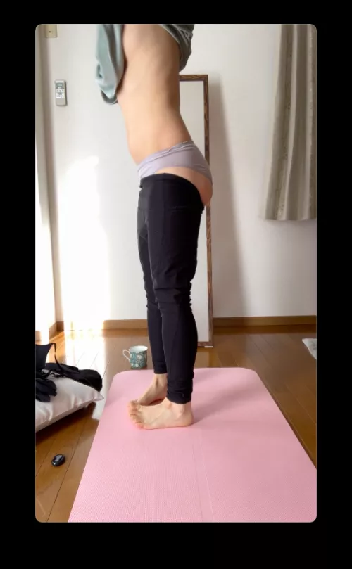 on yoga mat by window