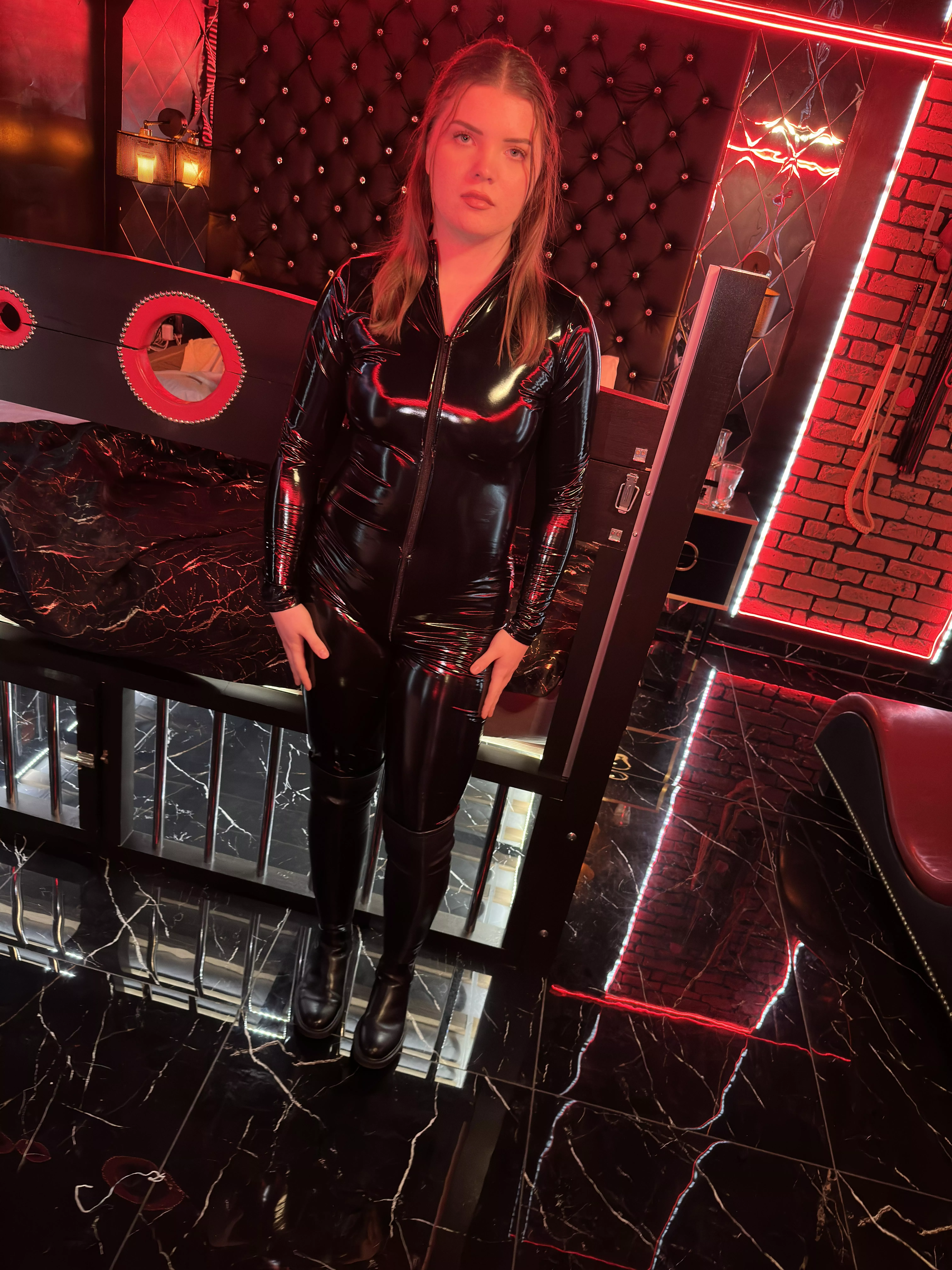 Wearing pvc catsuit in fetish room