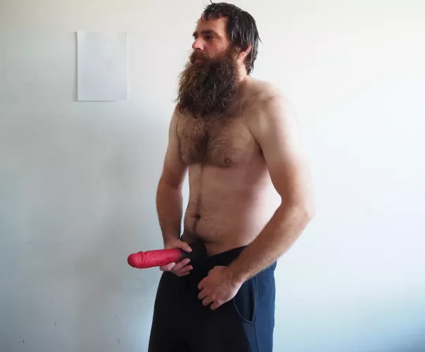 Bearded and barechest man with a 10,5 inch red dildo