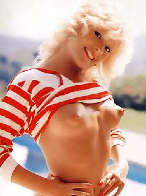 Perky and puffy. A vintage blonde flashing a smile and some nipples.