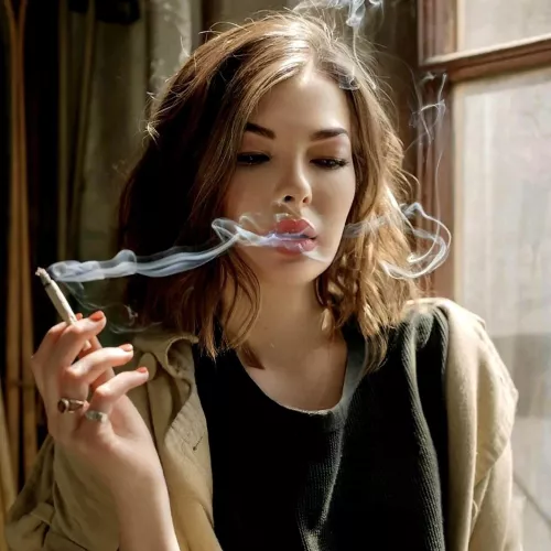 Fascinated by the allure of her own smoke