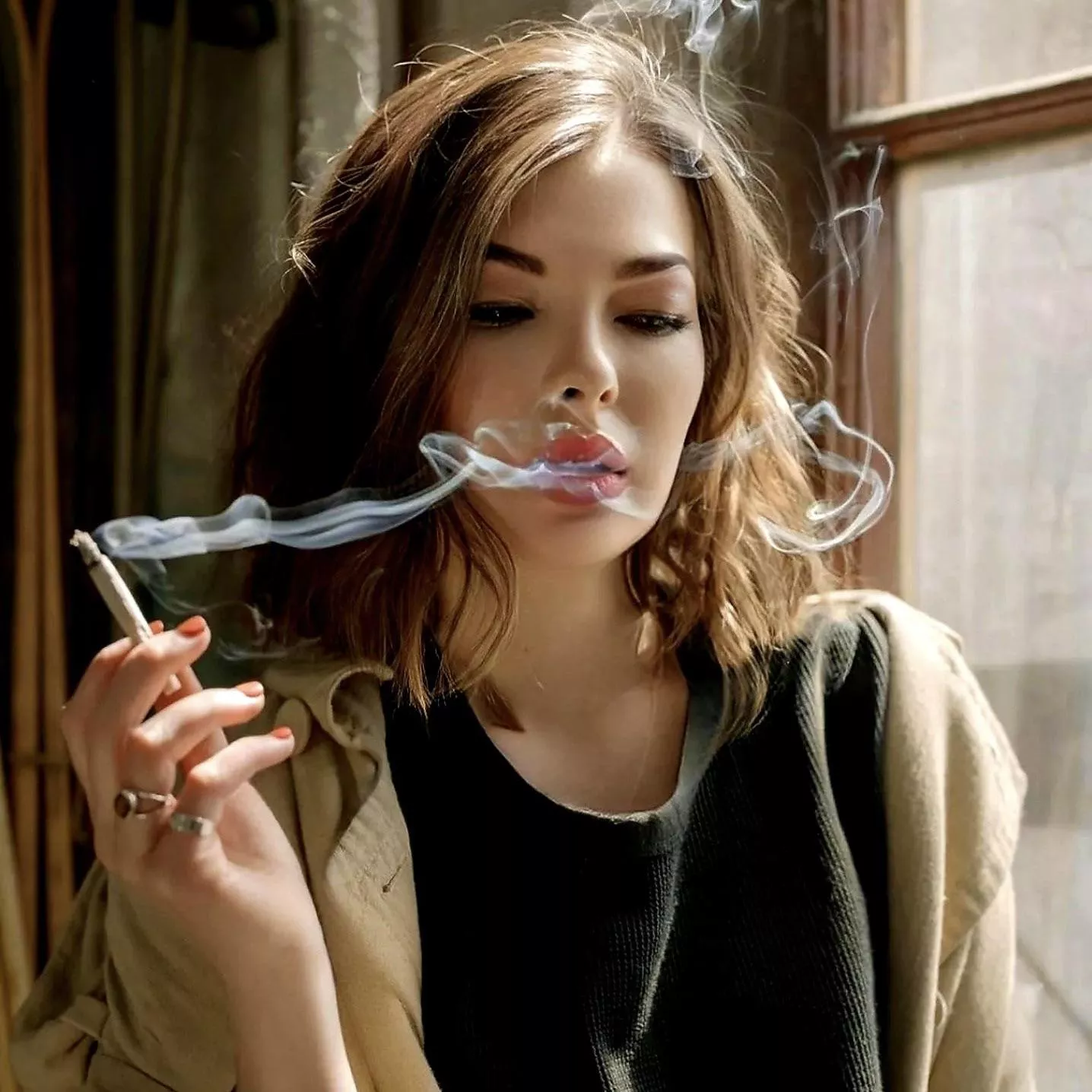 Fascinated by the allure of her own smoke