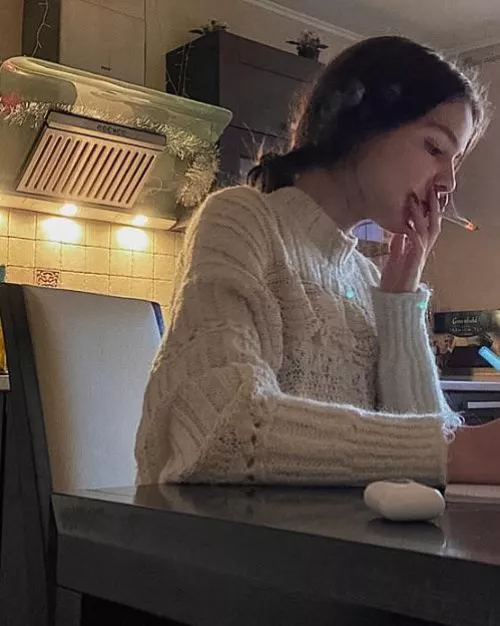 Whenever her roommates leave, Amy lights a cigarette and smokes while doing her homework 