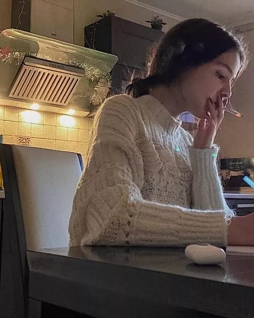 Whenever her roommates leave, Amy lights a cigarette and smokes while doing her homework 