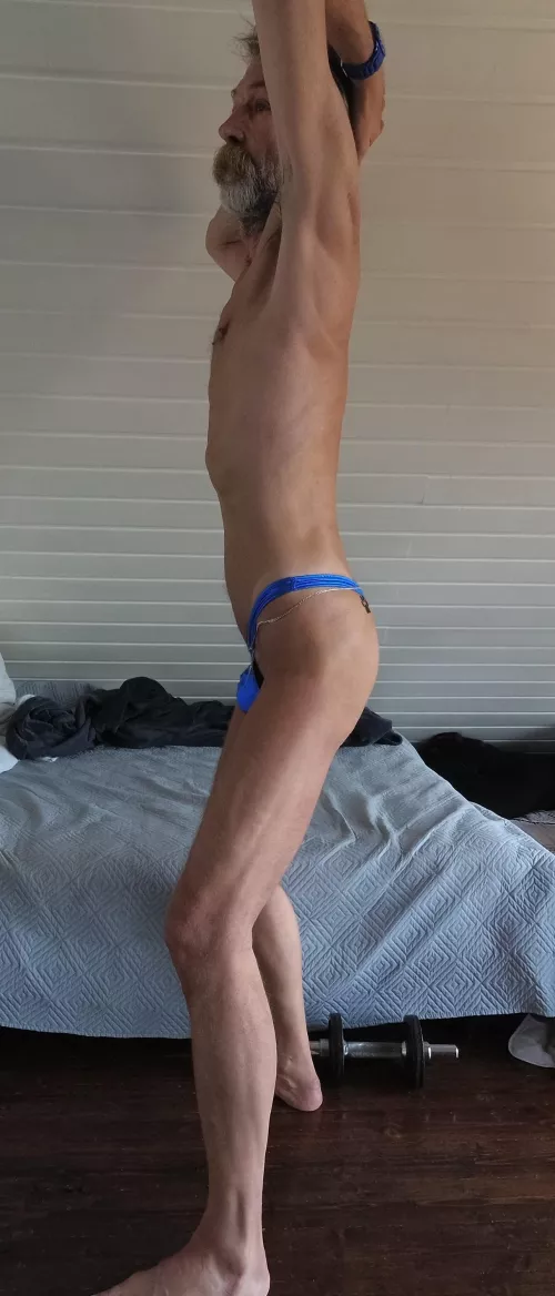 Presenting my super slim body only dressed with a blue metallic thong