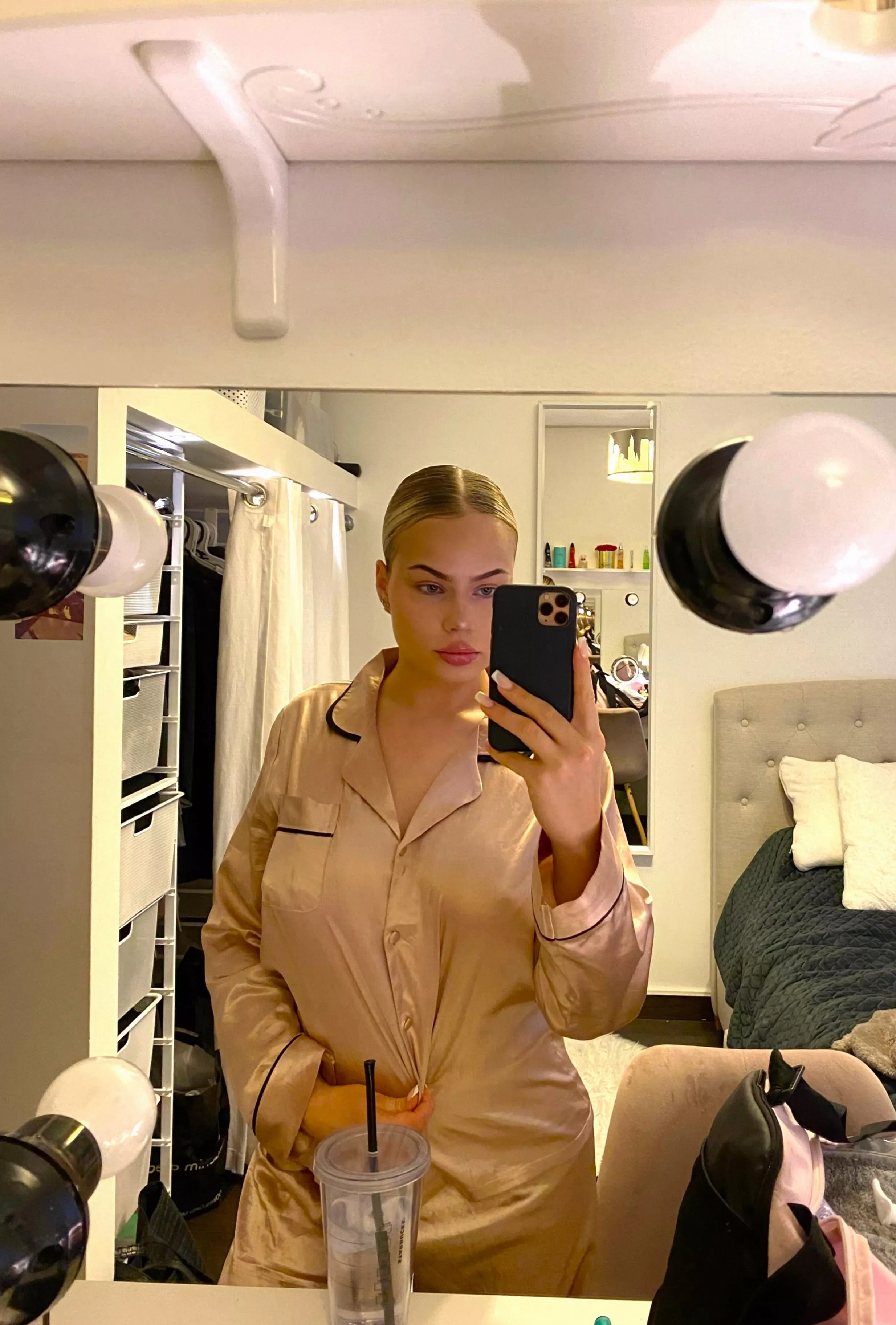 An ordinary selfie with a gentle smile in a low-cut dress and, of course, without a bra.