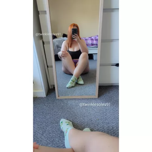 Green socks for this redhead