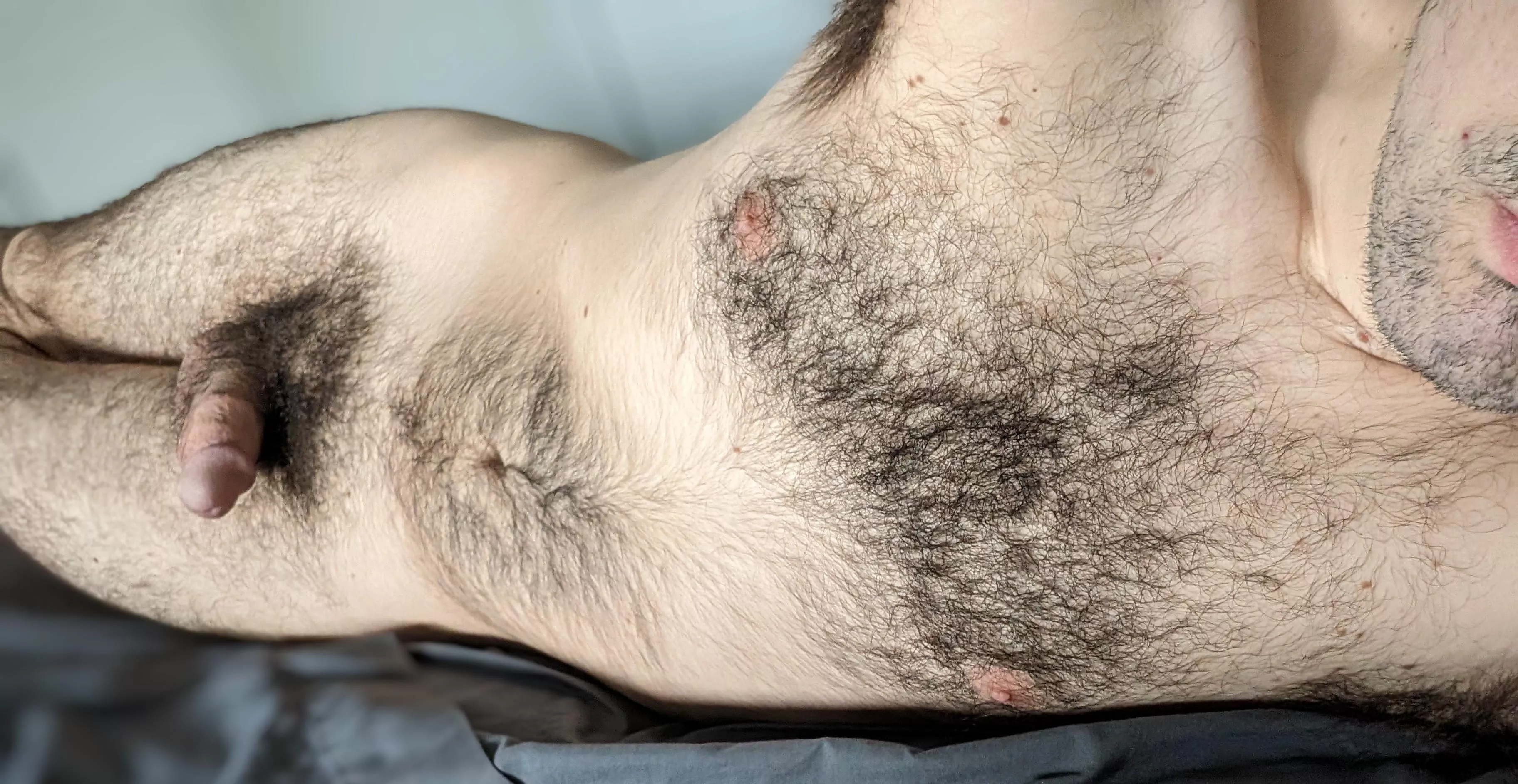 Laying in bed nude with a softy