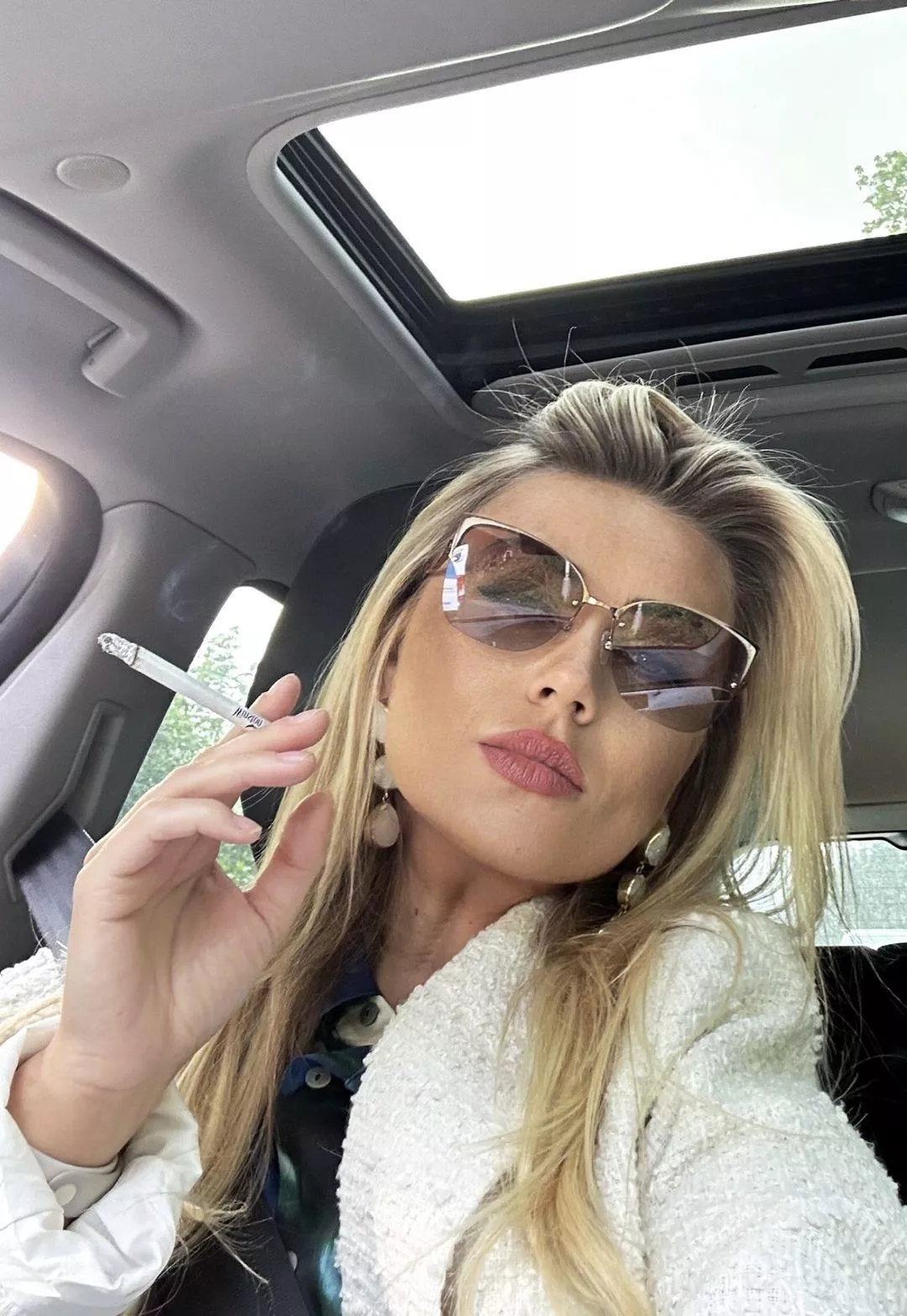 Self-assured and smoking in her car
