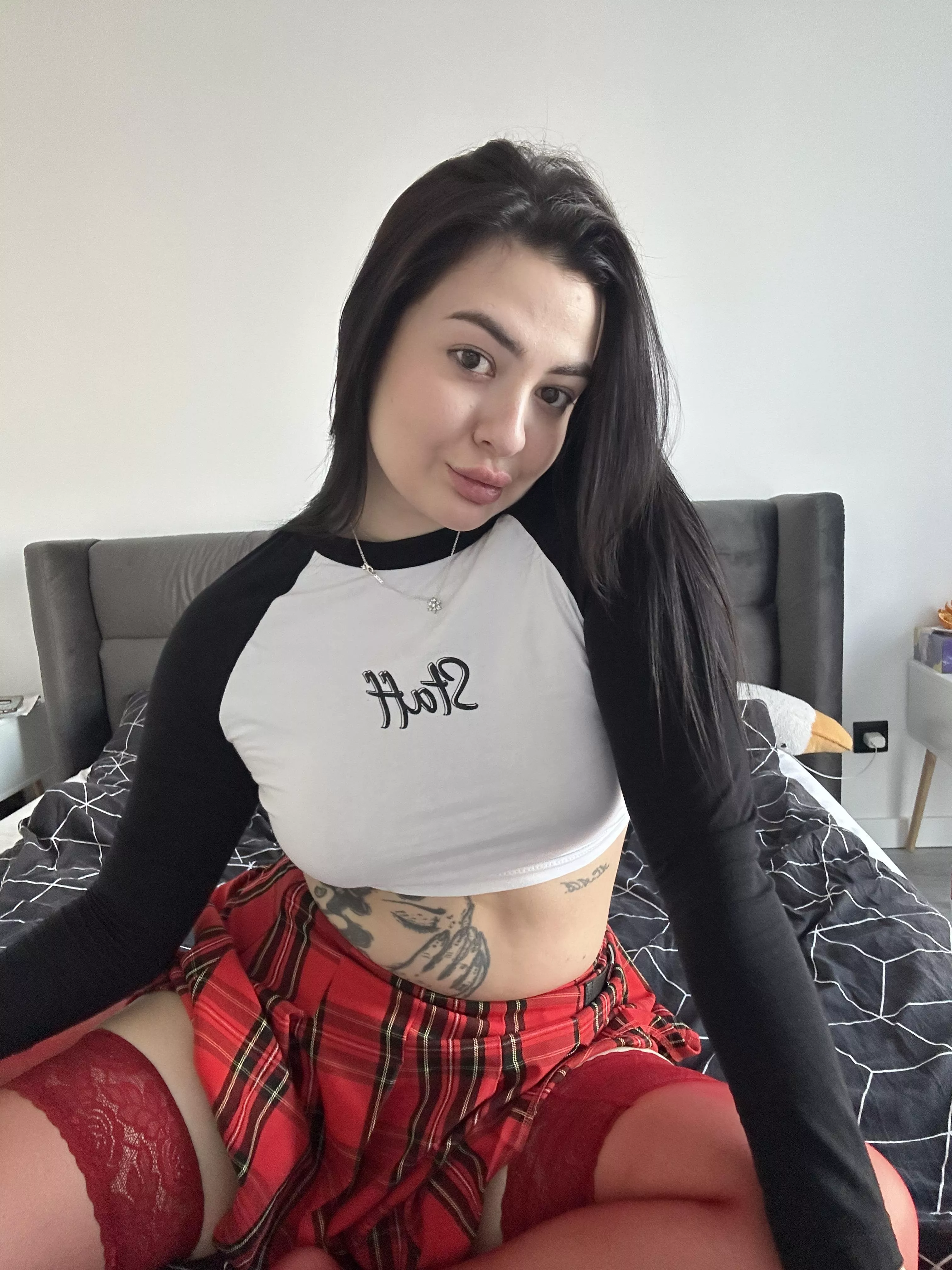 A brunette babe in a plaid skirt