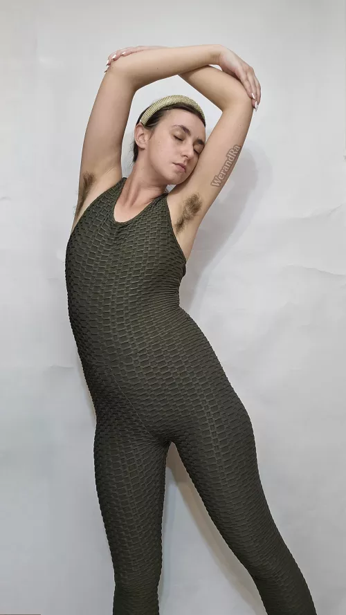 Hairy armpits enhance the look of dancer in green unitard
