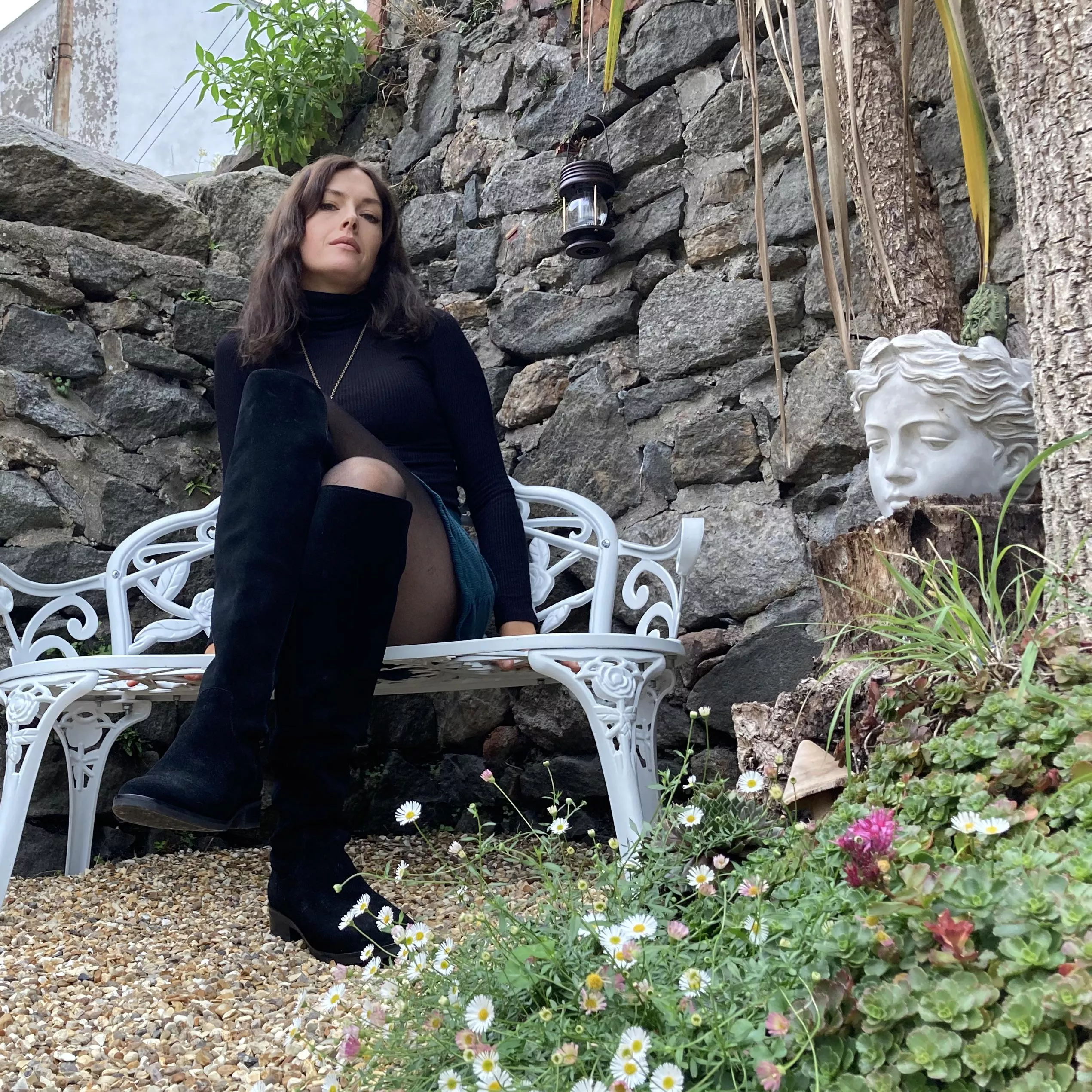 Knee high boots with stockings and a miniskirt