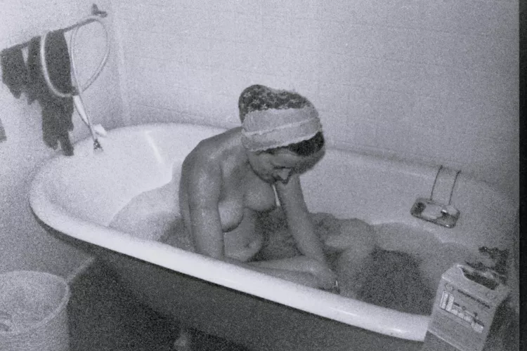 Yes, my turn for a bath! During cold weather, Saturday night was warm bath night on our hippie commune - this old tub kept the water warm. Early 1970s.