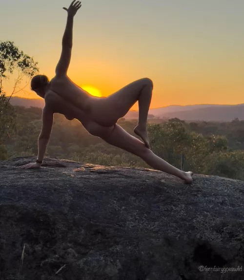 Sunset silhouette nude yoga self portrait on a rock ledge in Australia