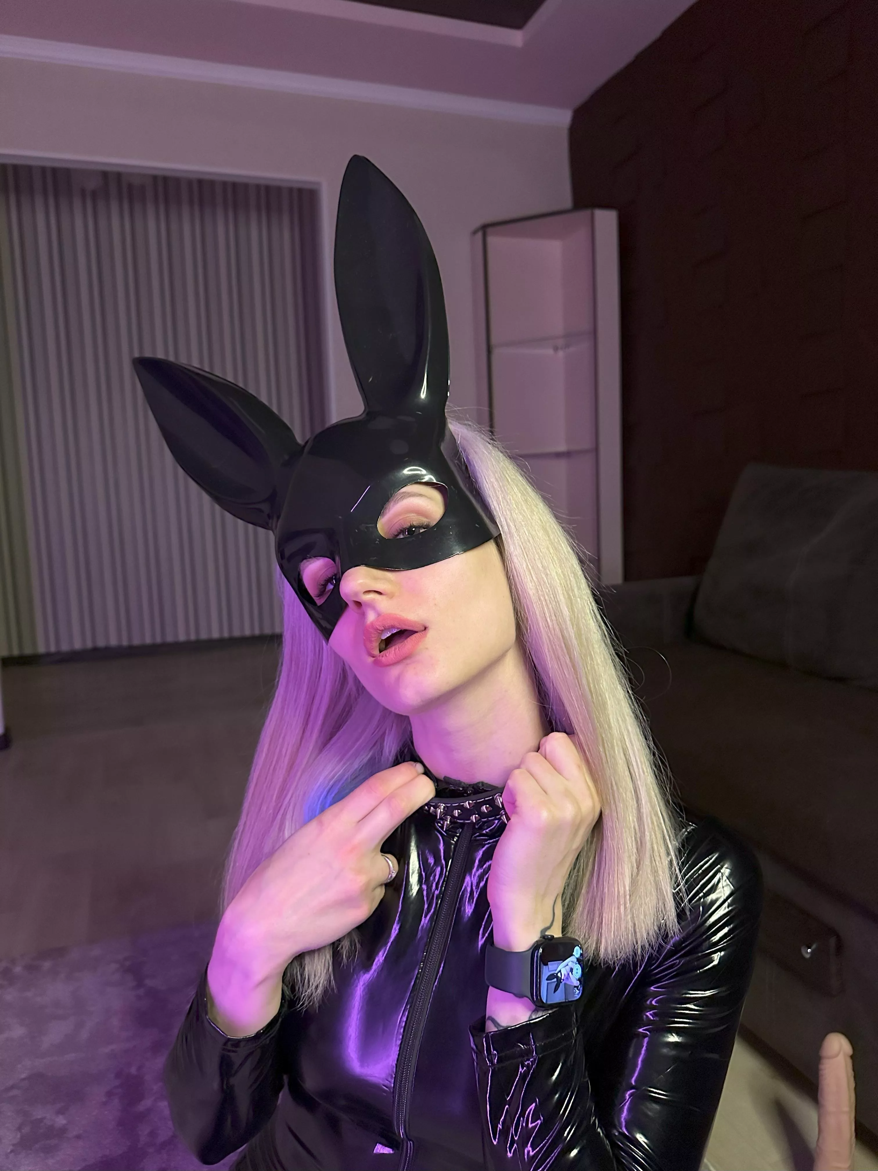 I begin to slowly unzip my latex suit, slowly revealing parts of my body