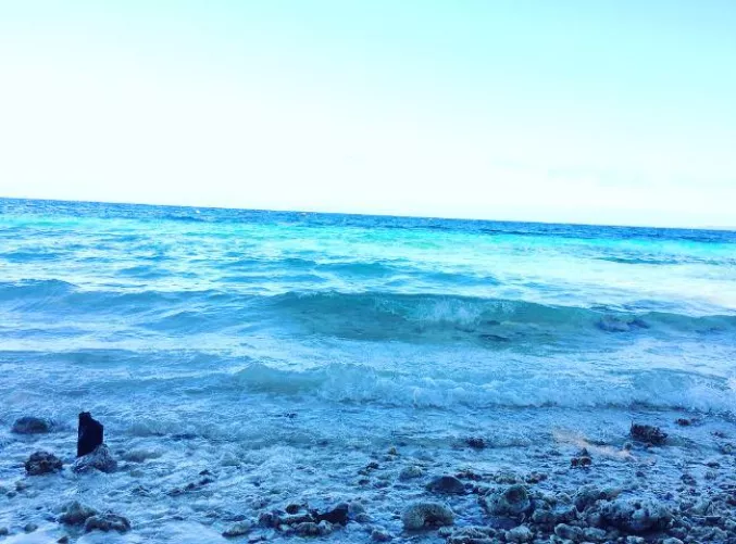 Just chillin' at the beach, savoring each sip of beer as the waves gently roll in, feeling a sense of peace wash over me.