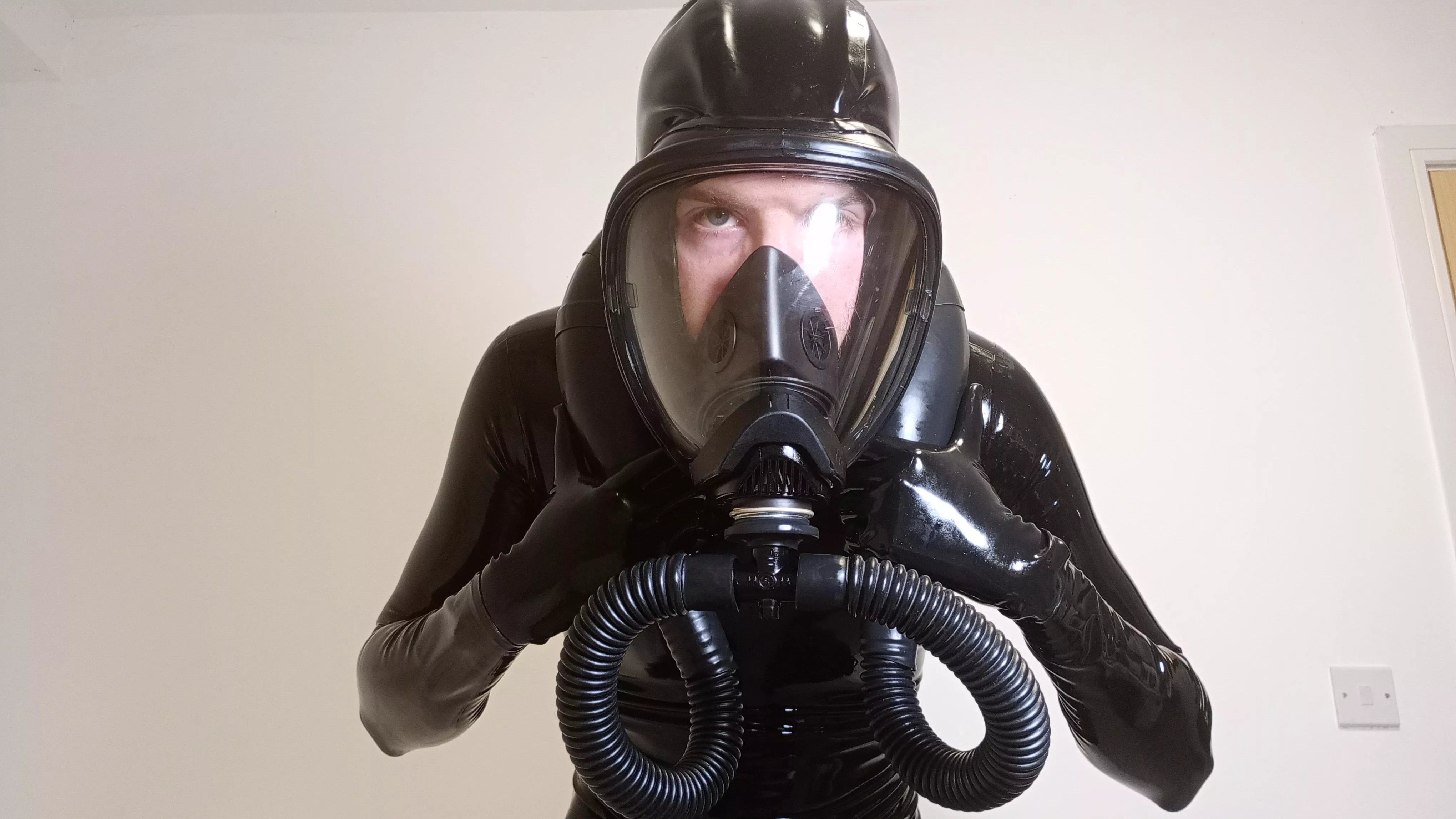 Hooded gas mask makes full enclosure easier