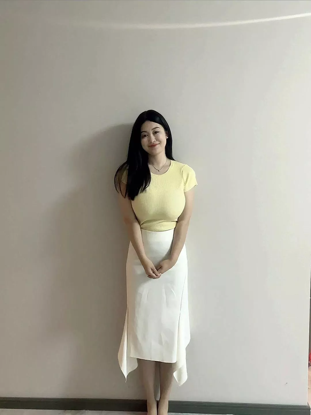 Asian in yellow shirt and white skirt