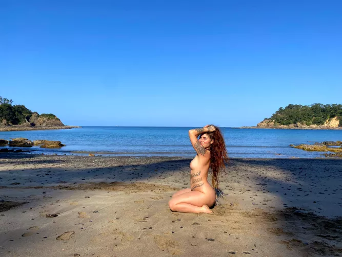 Naked and barefoot on the beach.