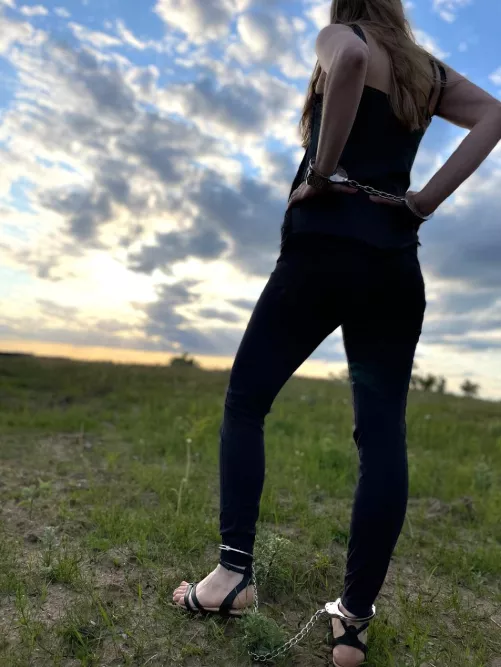 Enjoying the sunset in cuffs