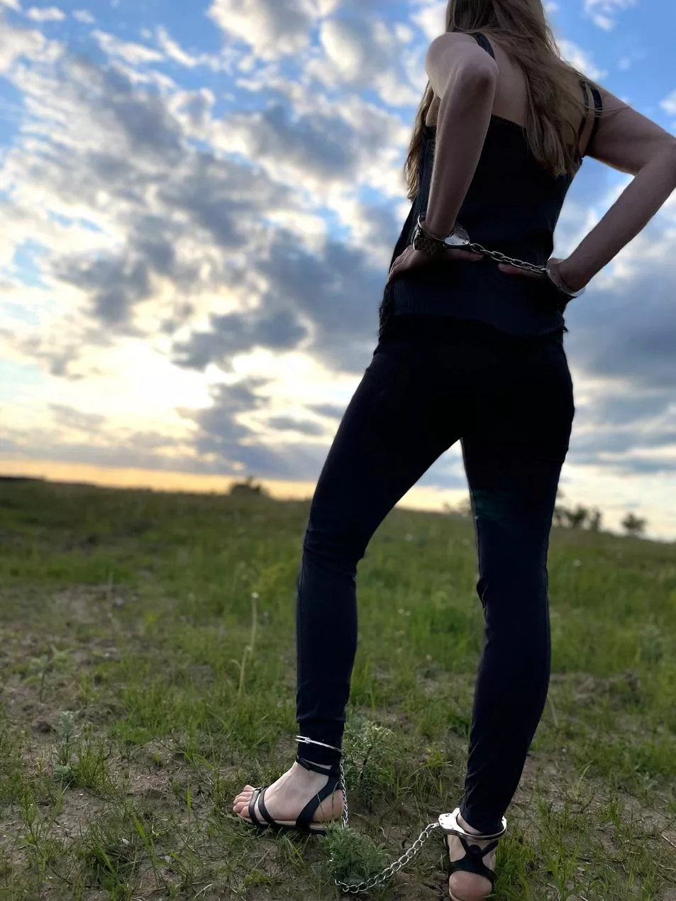Enjoying the sunset in cuffs