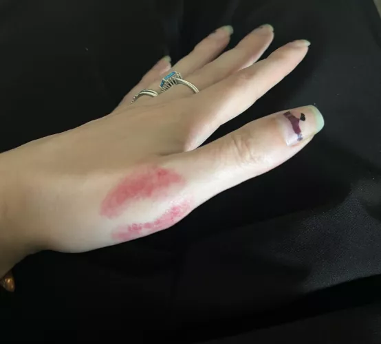 Hand with a lipstick kiss