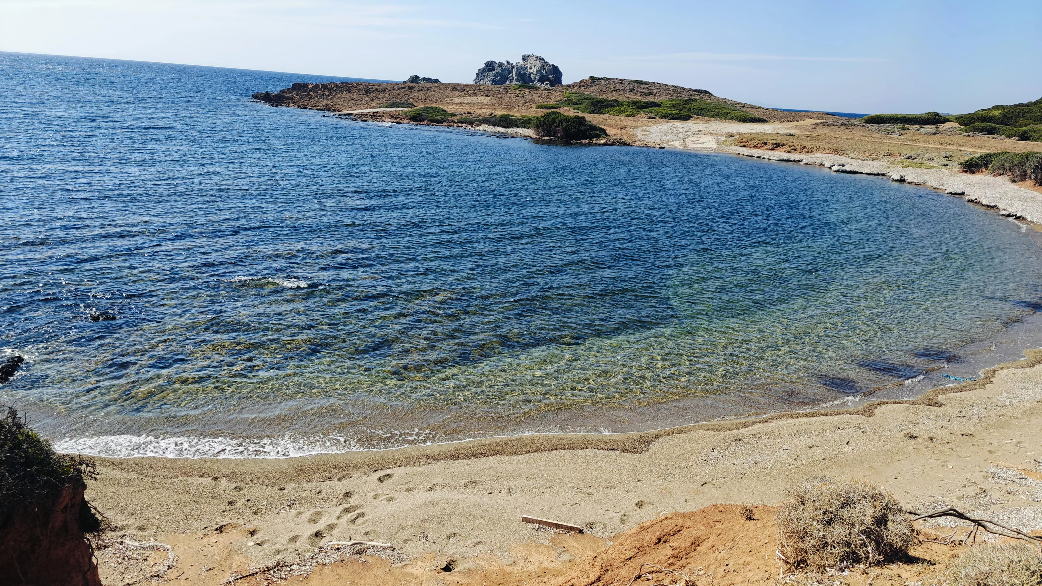 Small nudist beach with turquoise waters 