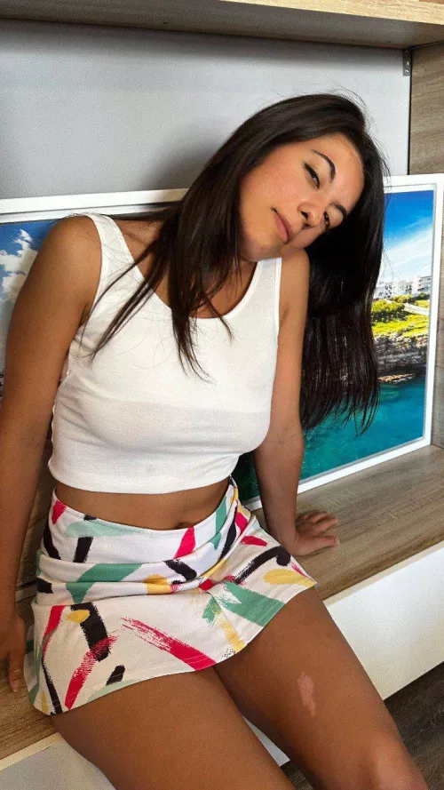 leaning on the wall, feeling flirty in colorful skirt babe