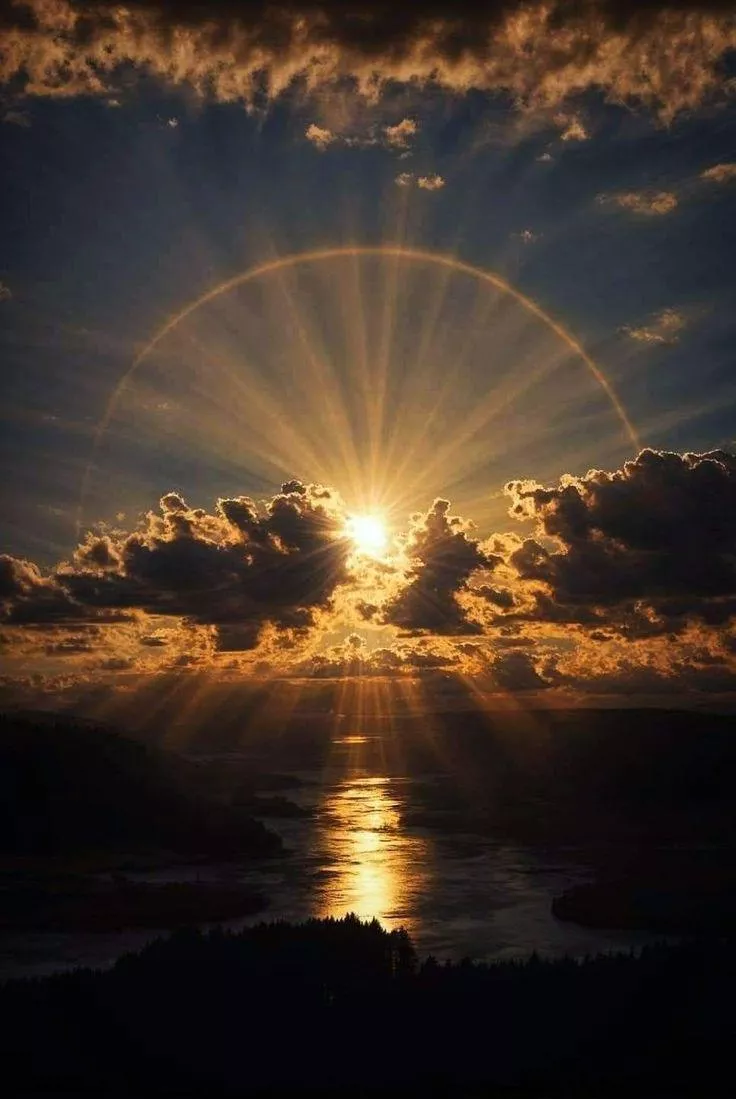 Circle of light on sun behind on huge cloud