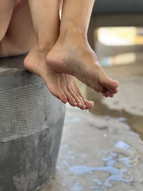 My feet are wet from the water in the pools