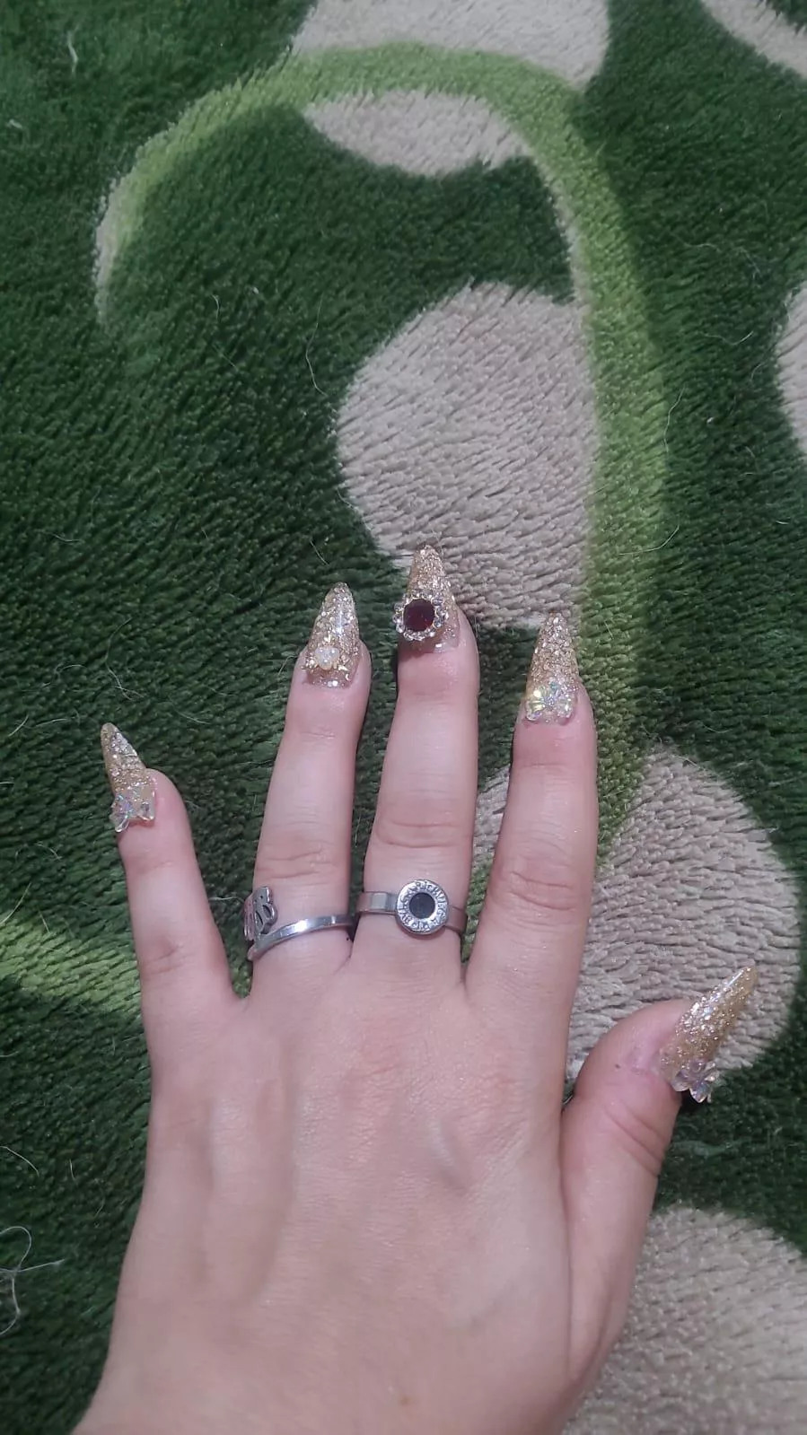 Strangely shiny nails with a lot of stones ♡