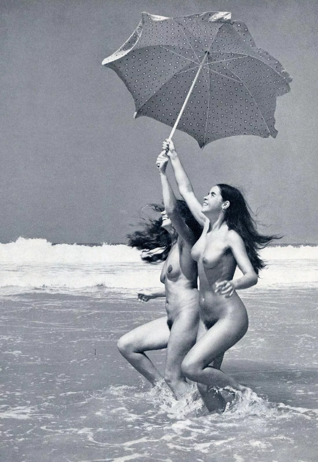 Nude beauties playing in beach. (1970s)