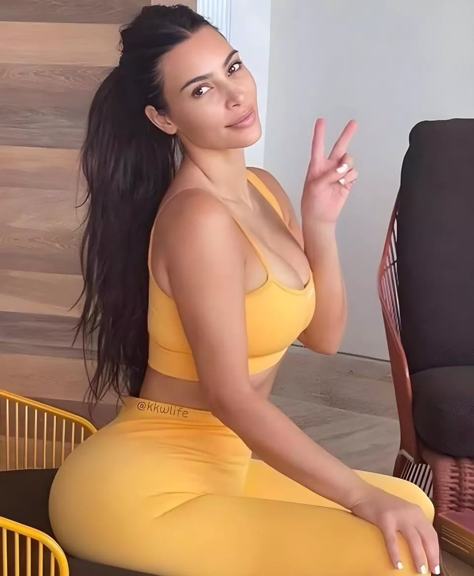 Kim’s gorgeous black hair and perfect tan curves, in her tight gym clothes