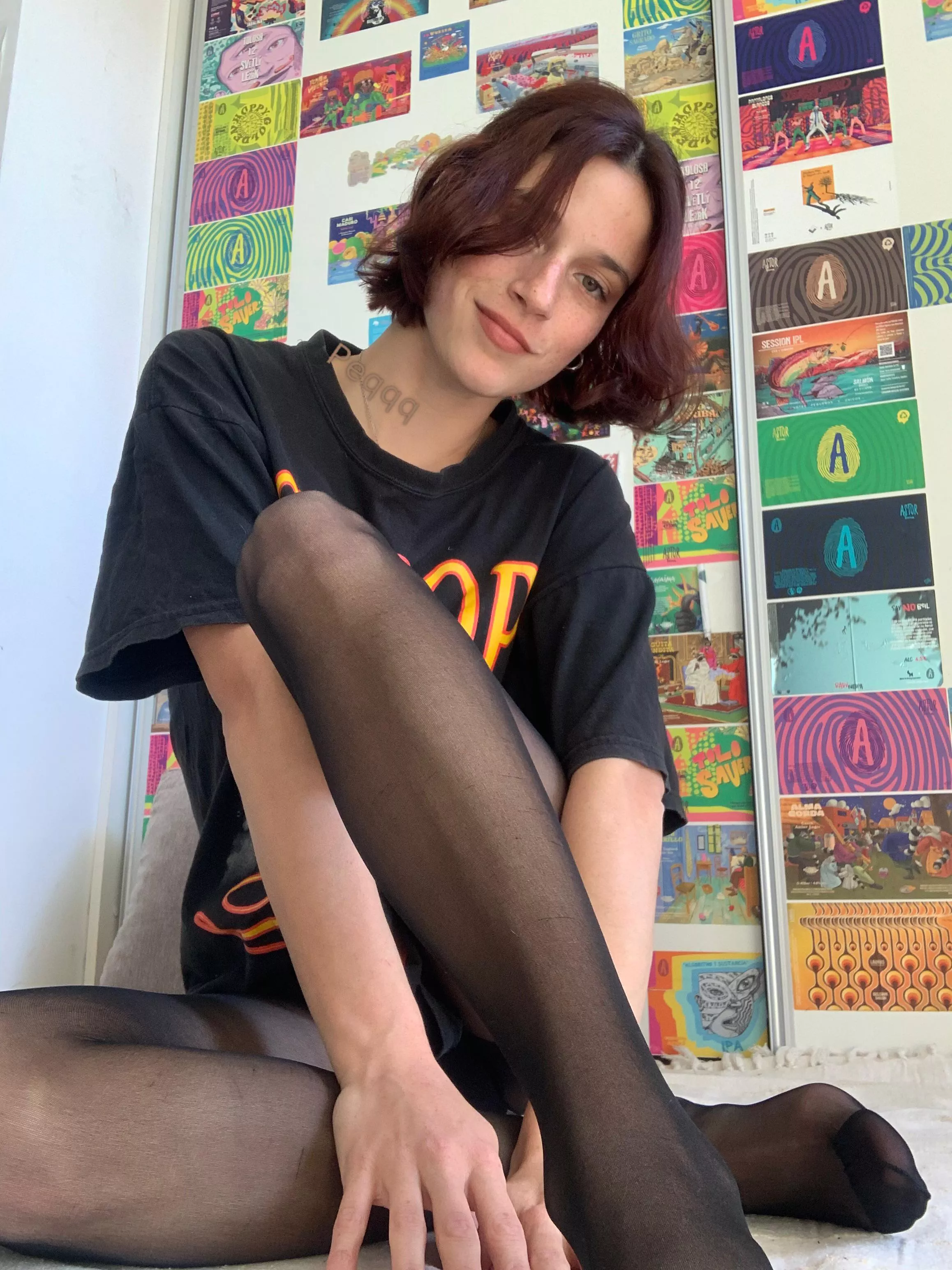 Black pantyhose and a shirt are the look 