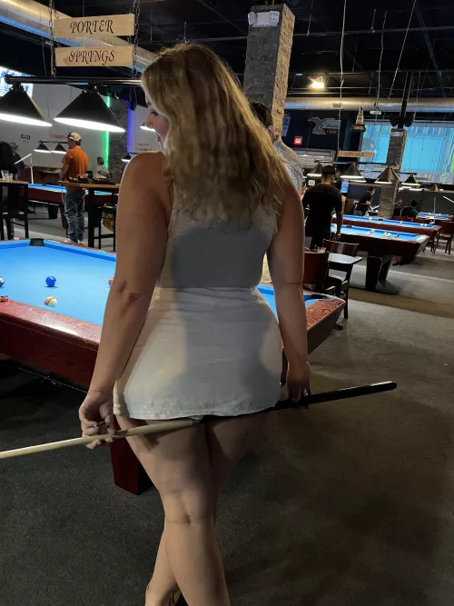 Short skirt and playing pool
