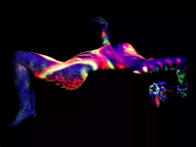 My naked body painted by an artist using fluorescent paint and ultraviolet lighting.