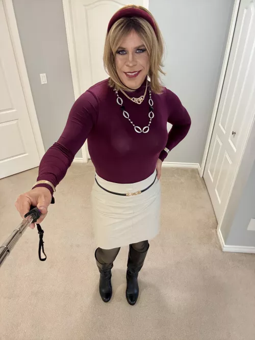 90% business and 10% sexy in this burgundy bodysuit, beige leather skirt and black knee high boots. 