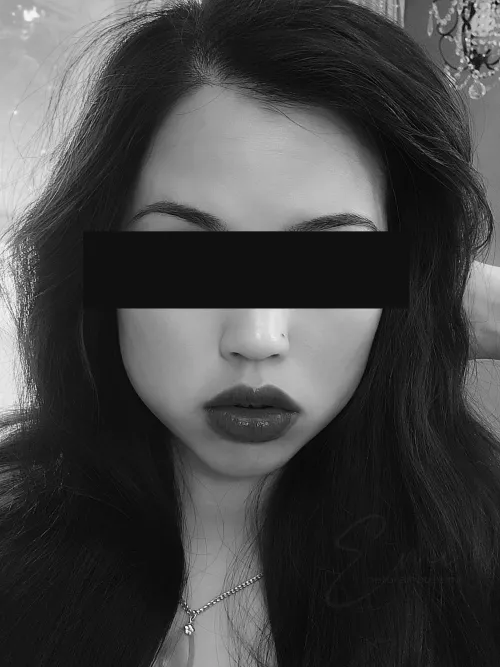 A pup without its owner just sits by the door.