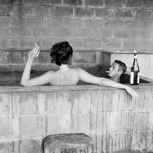 Steve McQueen & his wife, Neile Adams, taking a sulfur bath together in Big Sur, California, 1963