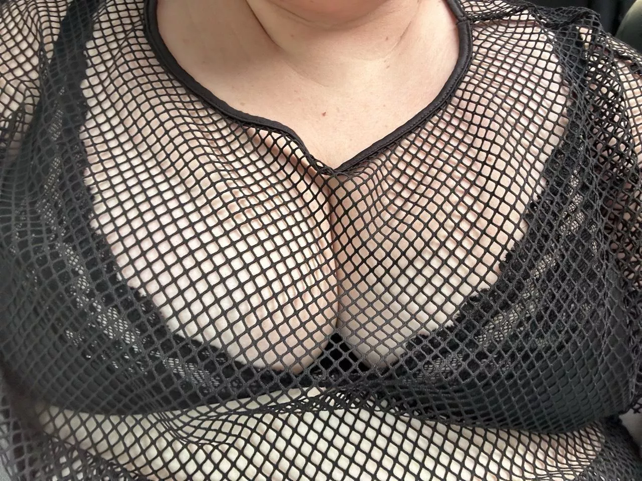 Fishnet shirt and lace bra 