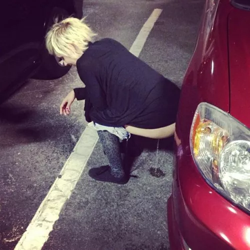 Leaning against a parked car