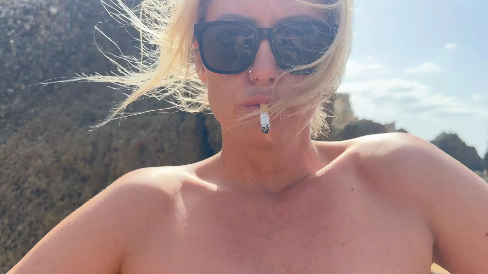 Smoking provocative at the nude beach 🔥