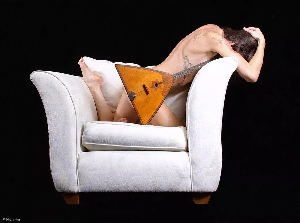 I know this one: this is a balalaika! Together with a modest nude.