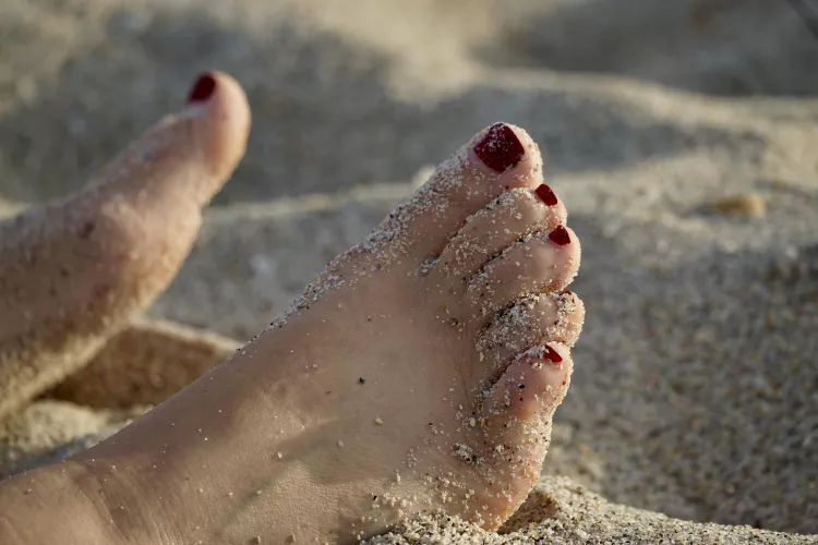 I got a drink in my hand, got my toes in the sand…