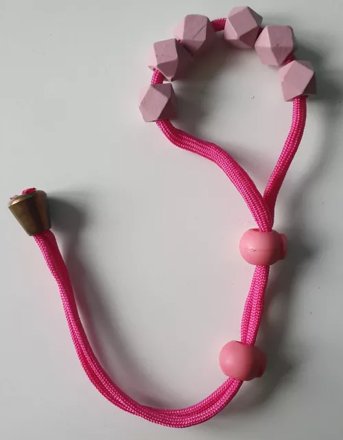sissy-pink Paracord Cock-Ball-Ring with wodden beads for more pressure & pleasure
