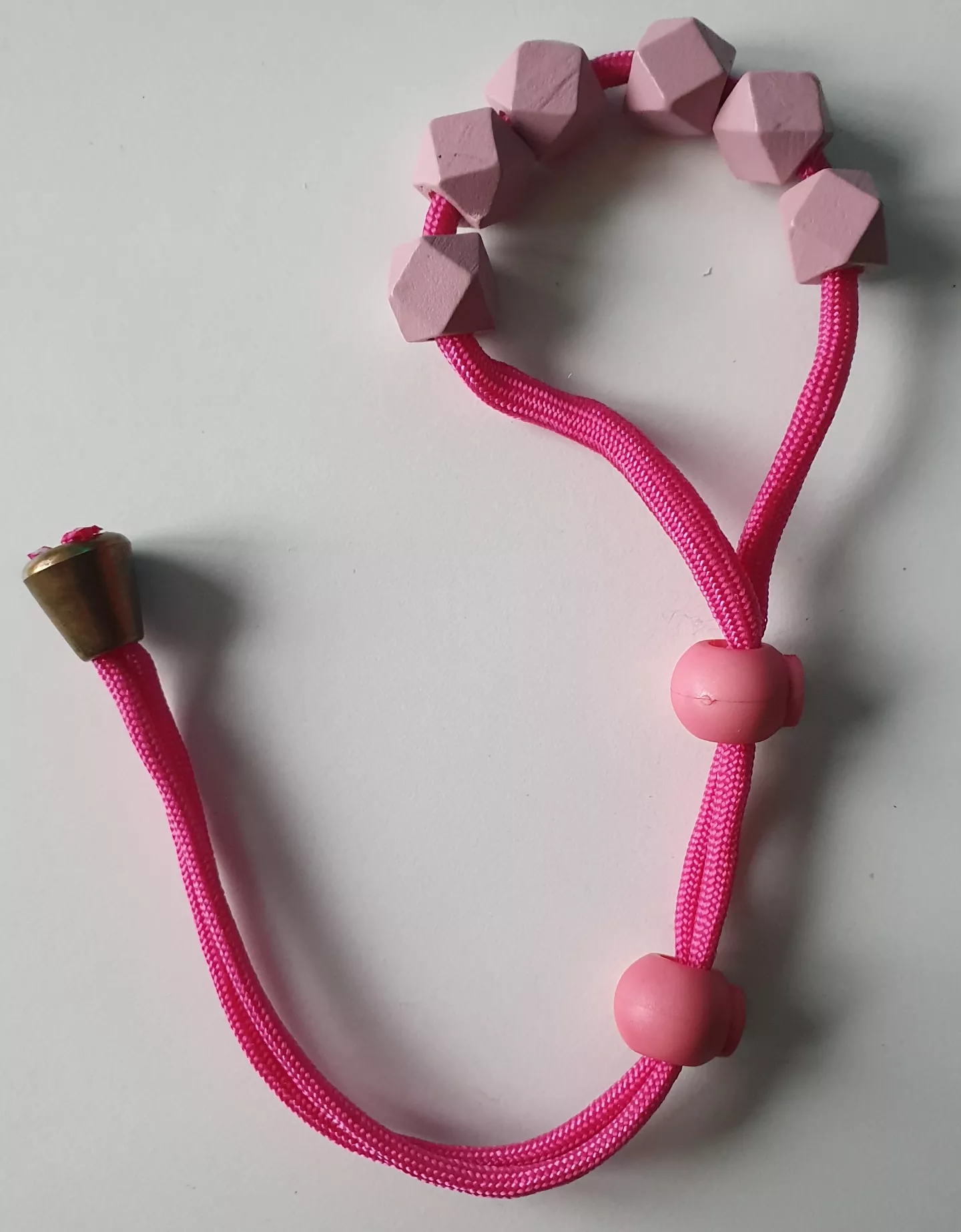 sissy-pink Paracord Cock-Ball-Ring with wodden beads for more pressure & pleasure